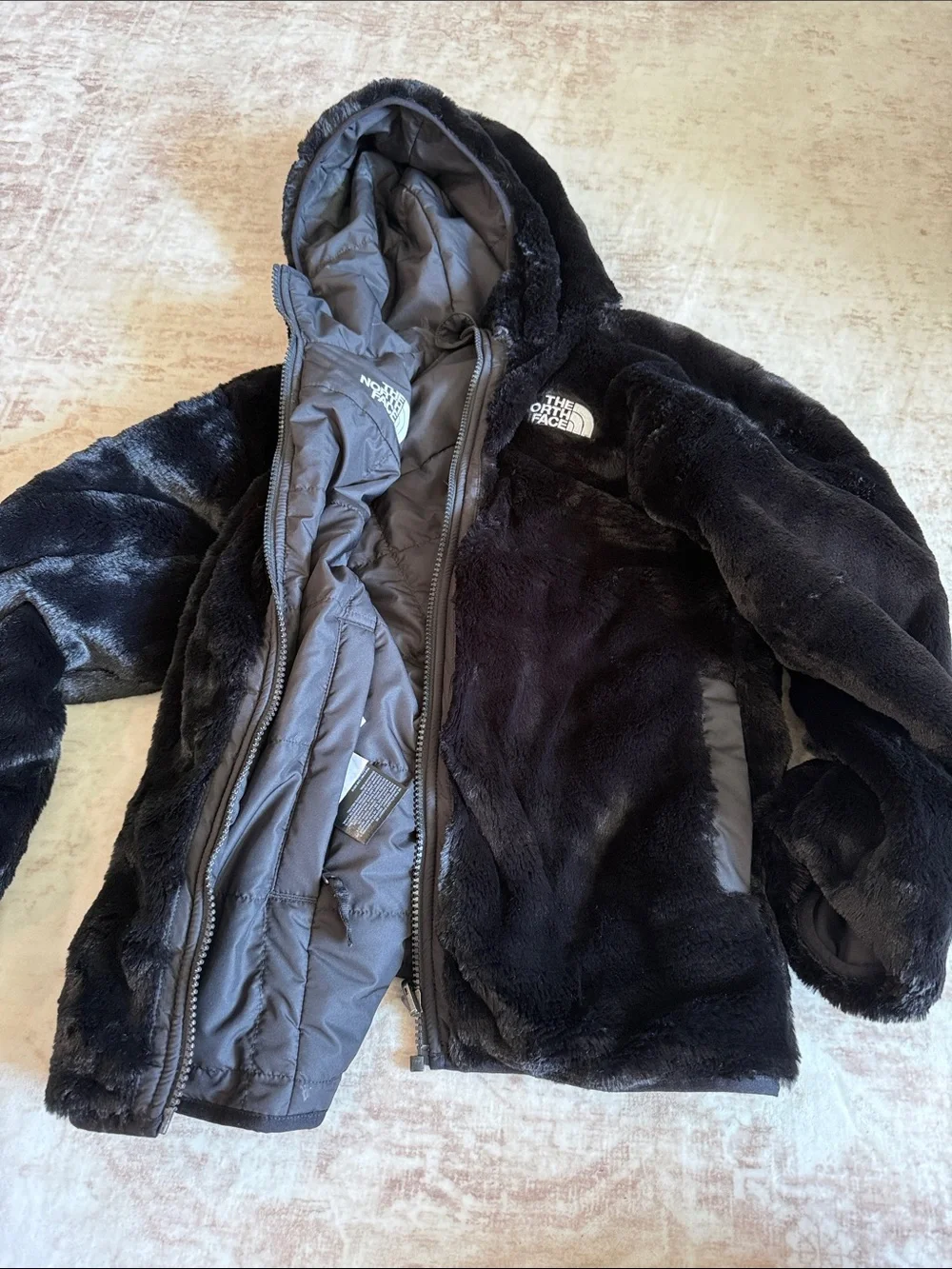 The North Face Children’s Hooded Faux-Fur Reversible Puffer Jacket in Black
